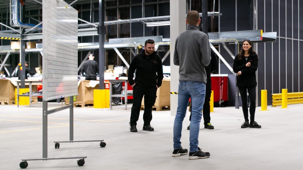 Team discussion during the setup of a new warehouse operation